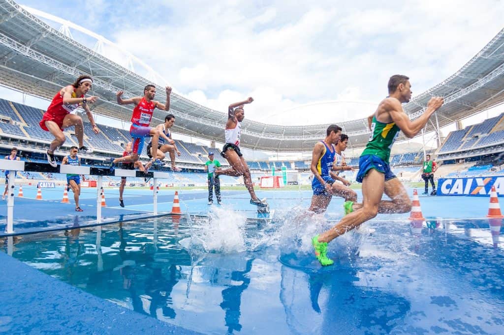 men competing in steeplechase
