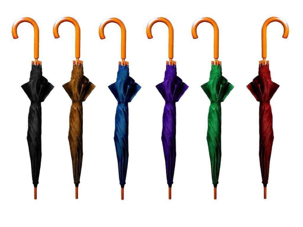 group of umbrellas with one pointing in a different direction