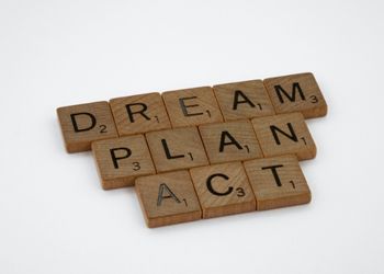 Dream. Plan. Act. in Scrabble tiles.